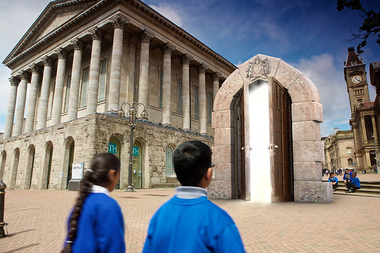 Campaign visual for the Schools of King Edward VI showing two school children looking into a magical door 