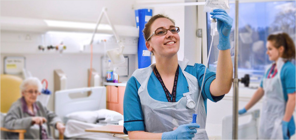 nurse  checking an intravenous drip in a hospital setting